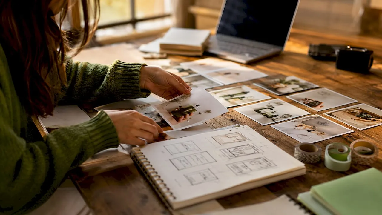 Hands arranging product images on table