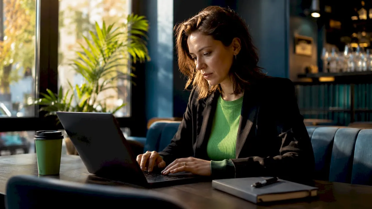 Woman typing localized ecommerce content in coworking space