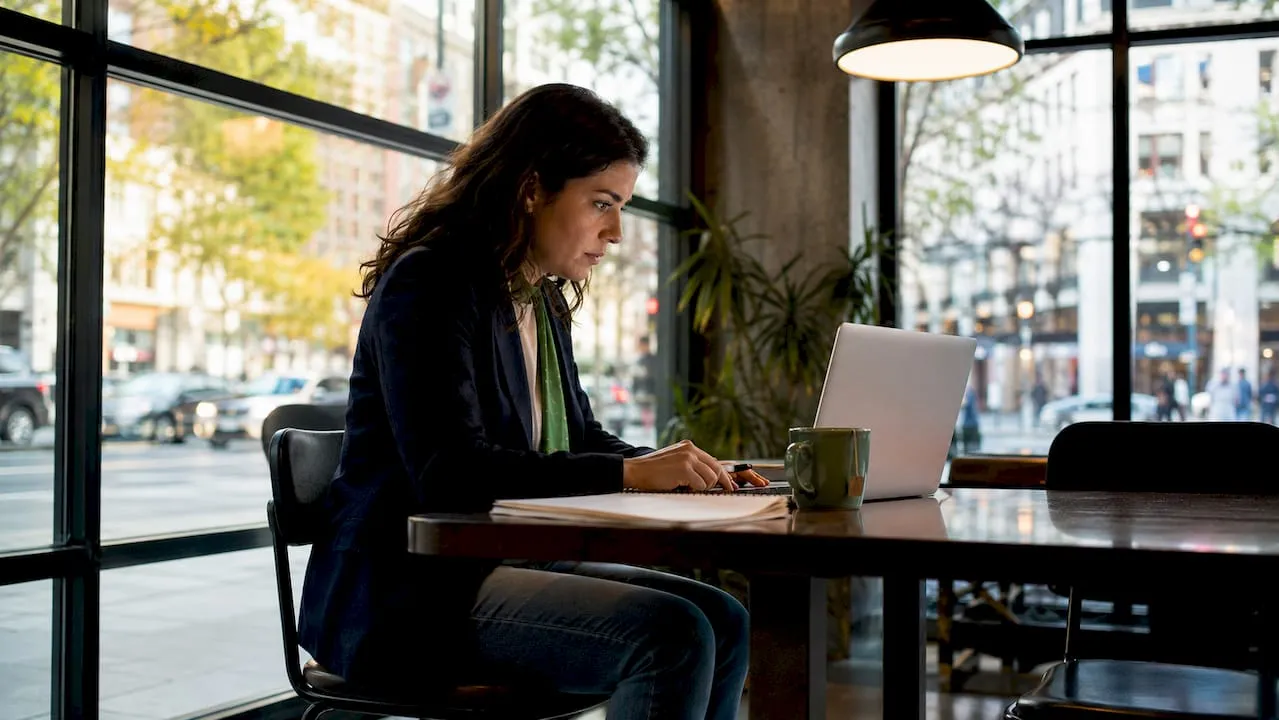 Woman working on AI product page generation laptop
