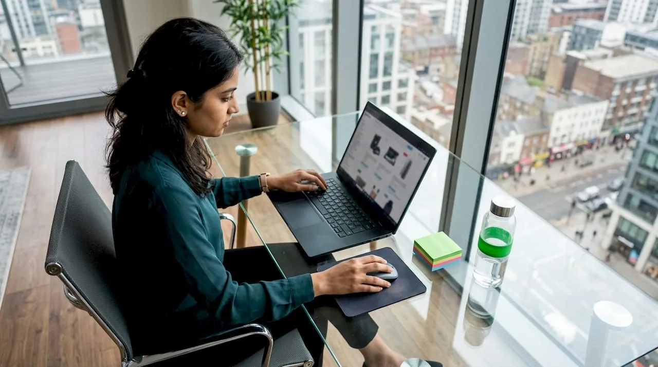 Woman analyzing product page on laptop
