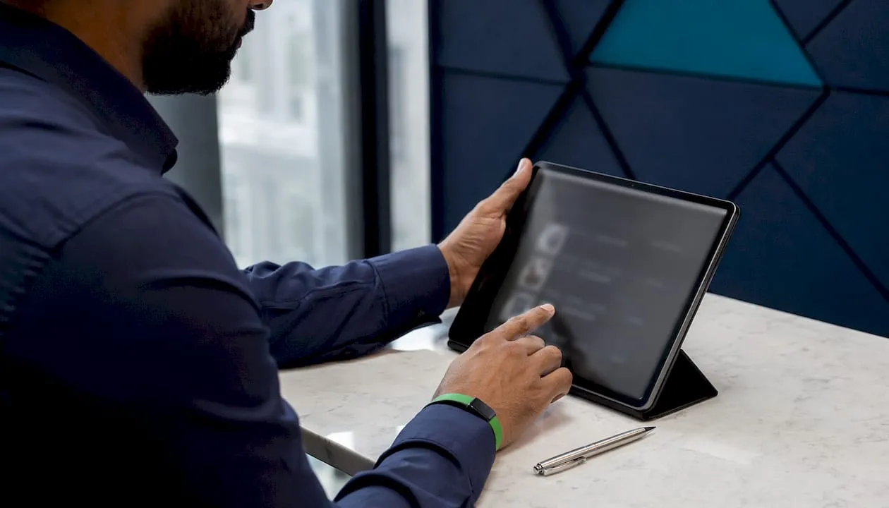 Hands using tablet for AI-driven product enrichment