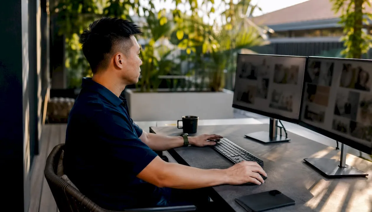 Marketer reviewing product images on monitors