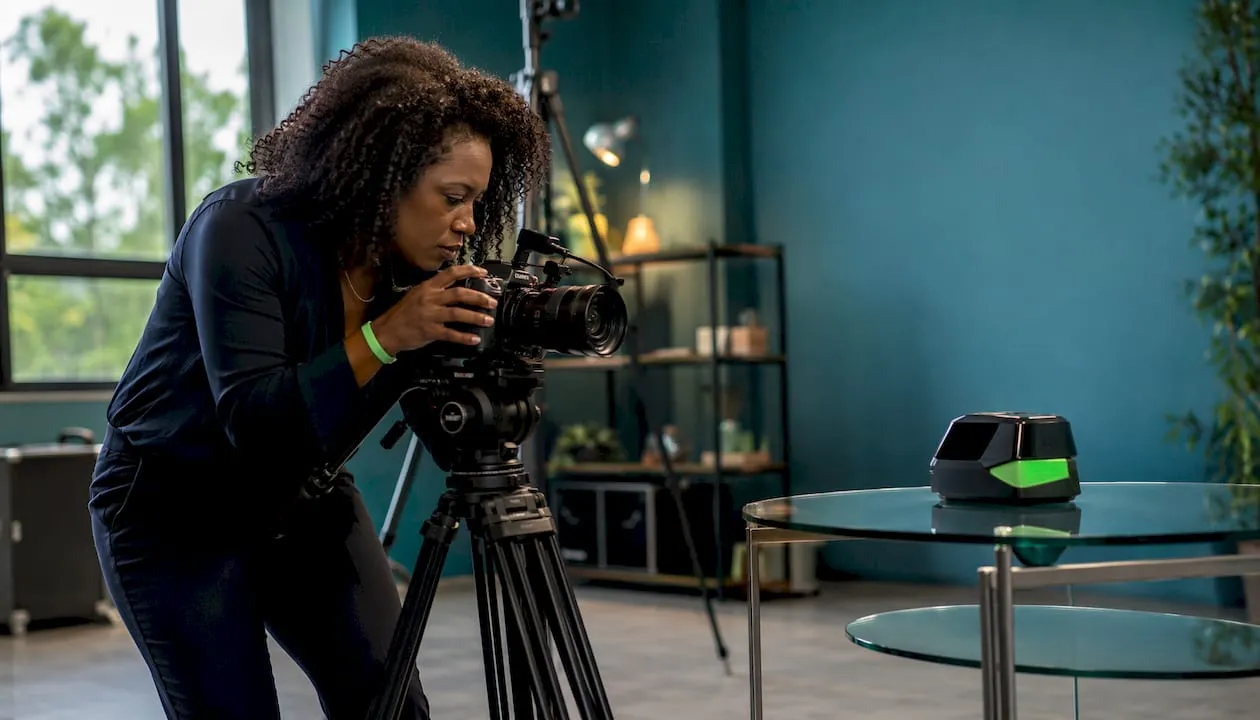 Videographer setting up product demo recording