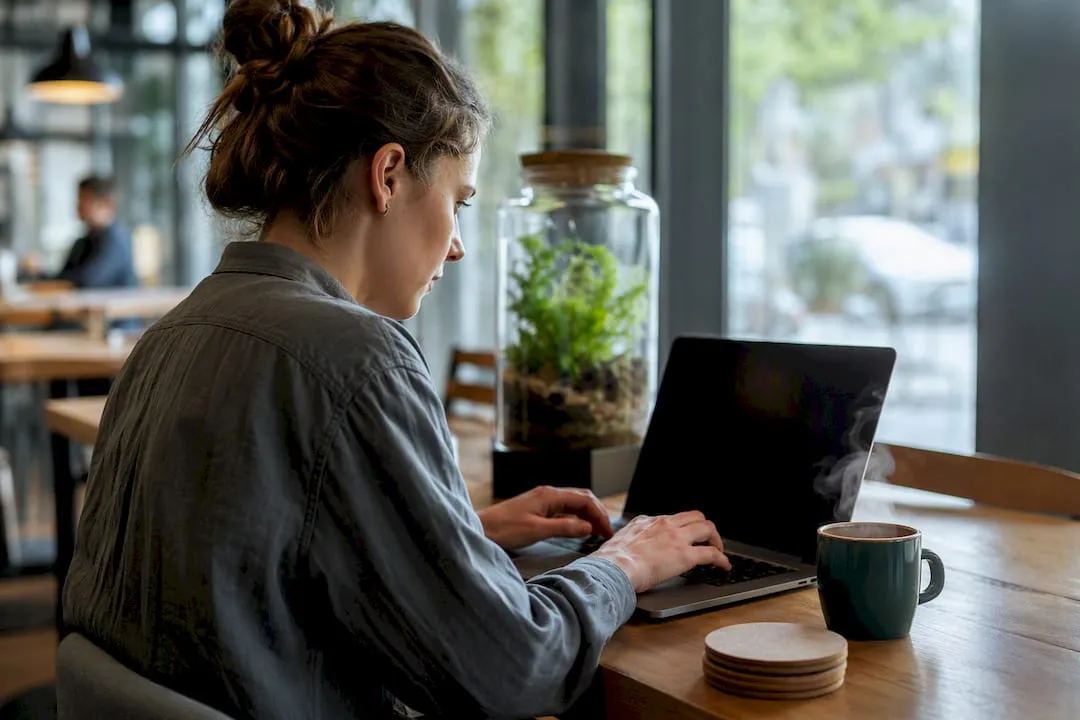 Hands typing alt text on laptop keyboard