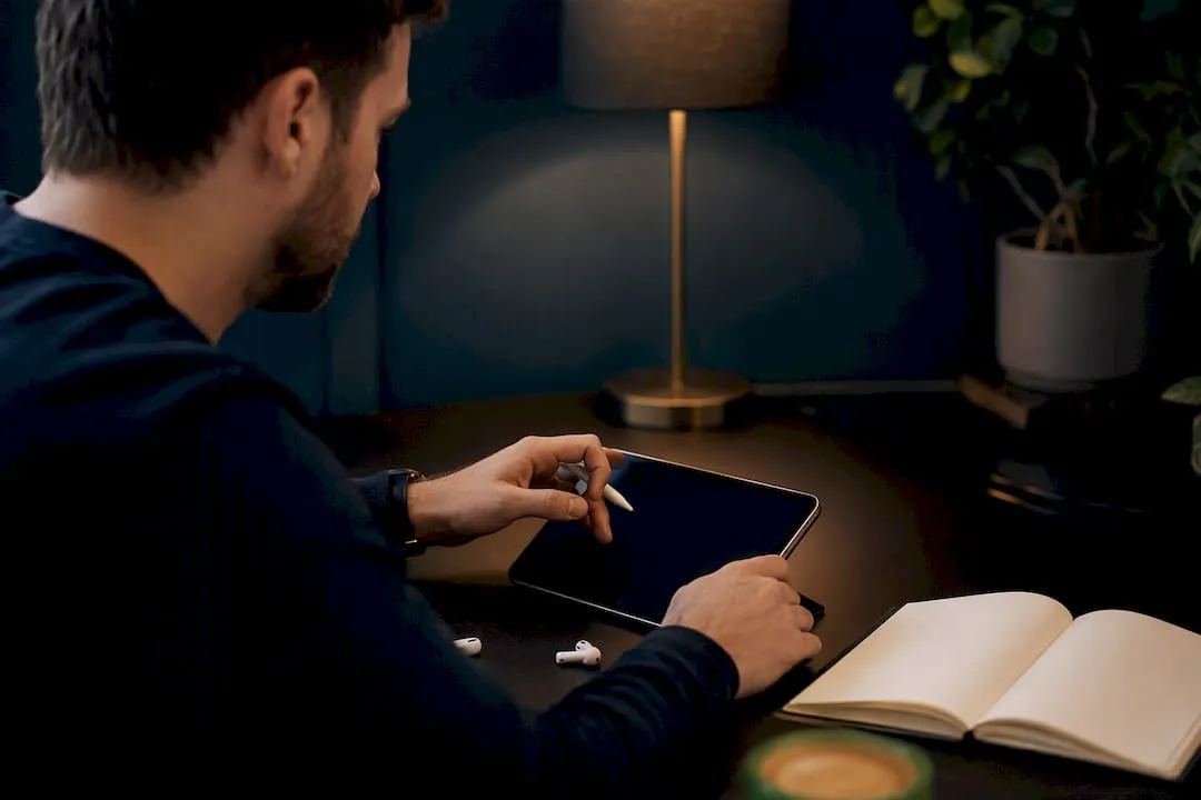 Hands updating alt text on smartphone at desk