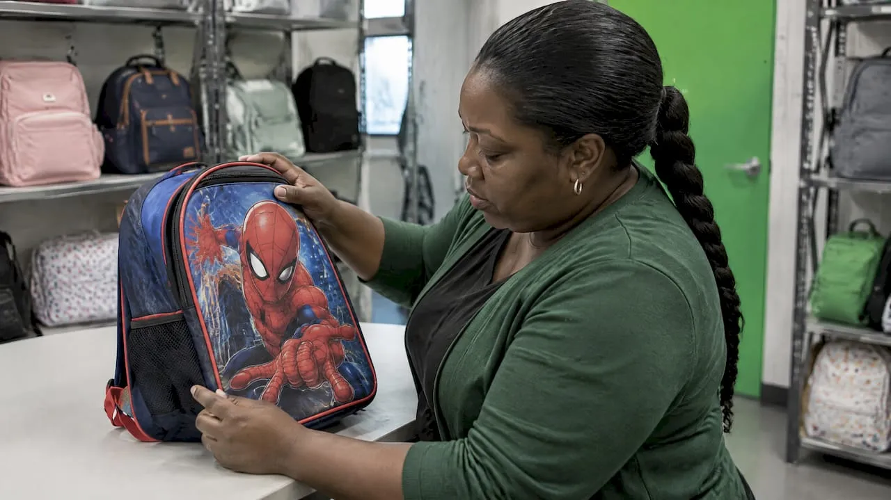 Retailer examining a Spider-Man children’s backpack
